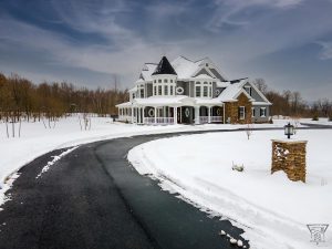 Jenkins Township home exterior driveway entrance, snow covered with clean asphalt driveway