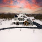 Front of Jenkins Township home exterior, snow covered. with sunset colored clouds.
